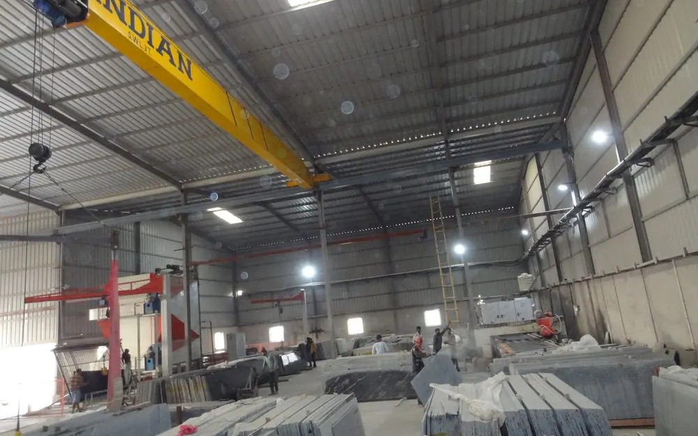 Processing hall at the Sankalp Granites unit in Kishangarh, with gantry crane and slab stacks