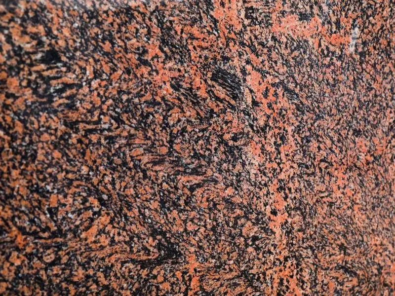 Tiger granite slab: dark base with red-orange waves